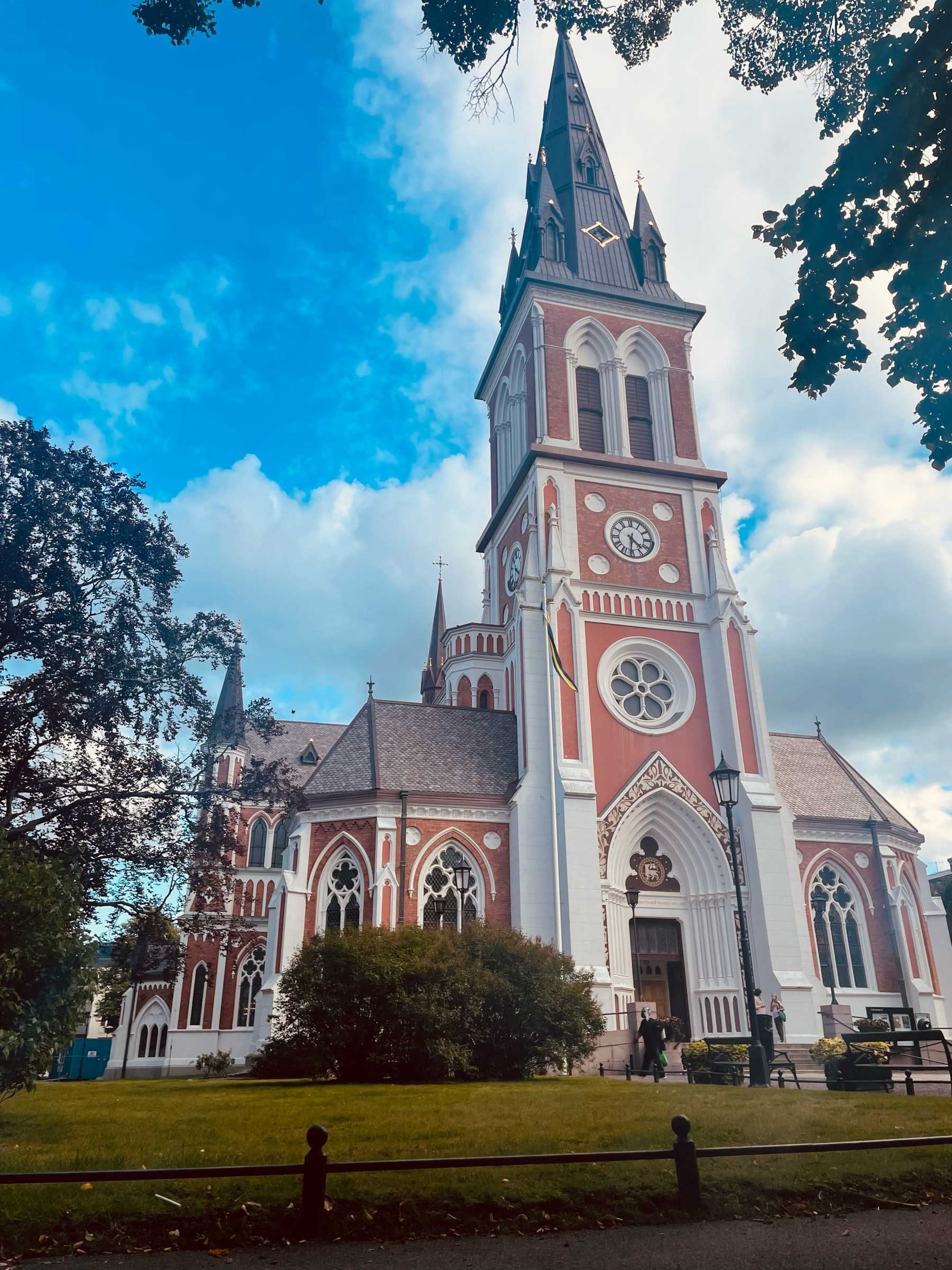 A red and white church under a blue summer sky in Jönköping, Sweden